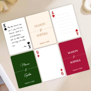 May include: A collection of custom playing cards with wedding details. The cards feature names "Mason & Sophia" and the date "August 21, 2026". One card has a quote, and others display card suits and numbers. The color palette includes cream, green, and burgundy.