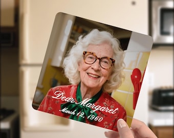 May include: A square photo print featuring a smiling elderly woman with white hair and glasses. The woman is wearing a red floral shirt with a green bow. The text "Dear Margaret March 12, 1960" is printed on the photo.