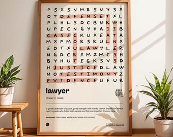May include: A framed print with a wooden frame featuring a word search puzzle with the word "lawyer" highlighted in pink. The definition of "lawyer" is printed below the puzzle. Two potted plants sit near the print.