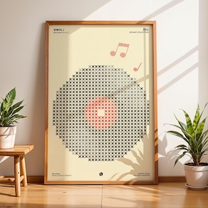 May include: A rectangular framed poster featuring a graphic of a vinyl record composed of black and grey cross-stitch patterns with a red centre. The cream-coloured background includes pink musical notes and text reading VINYL/ and BITMAP COLLECTION.