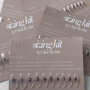 May include: A collection of nail sizing kits by Chae By Her. Each kit includes a card with instructions and a row of clear, numbered nail samples. The text on the card reads "sizing kit" and "by Chae By Her".
