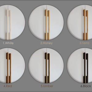 May include: Six white circular cabinet doors with different colored wooden handles. The handles are labeled: White, Honey, Terra, Red, Umber, and Black. The handles are vertical and have a rectangular shape.