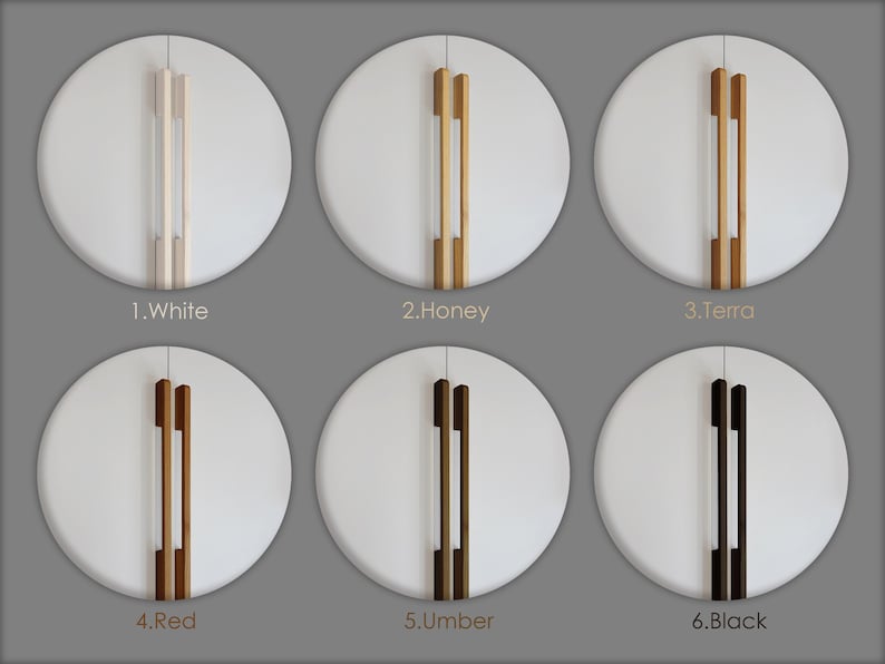 May include: Six white circular cabinet doors with different colored wooden handles. The handles are labeled: White, Honey, Terra, Red, Umber, and Black. The handles are vertical and have a rectangular shape.