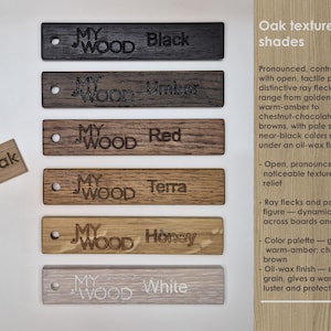 May include: A display of wooden samples in various colors, including black, umber, red, terra, honey, and white. Each sample is labeled with the color name and the "MY WOOD" logo. A small "Oak" sample is also present.