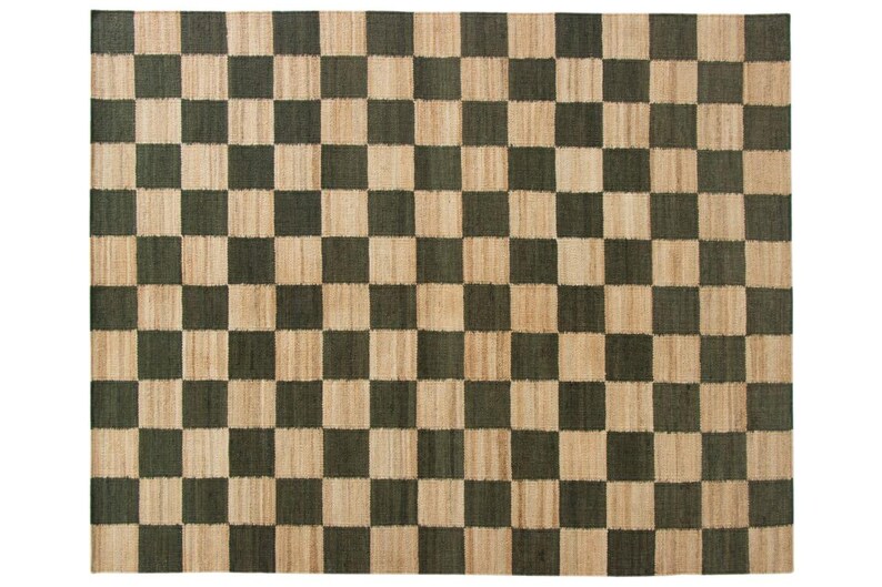May include: A rectangular rug with a checkerboard pattern. The design features alternating squares of dark green and natural beige. The rug is made of a woven material, likely jute or a similar fiber, and is suitable for indoor use.
