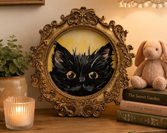 Black cat in miniature frame