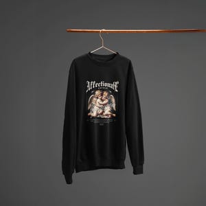 Affectionate Black Sweatshirt Featuring Two Hugging Baby Angels  Cute, Heartwarming Design Perfect for Unisex Everyday Wear