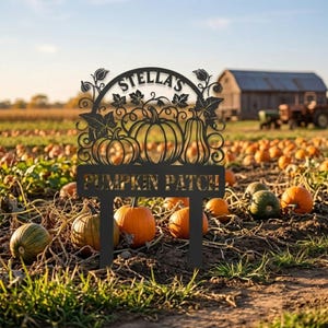 May include: A black metal garden stake featuring a cutout design of pumpkins, vines, and leaves. The text "STELLA'S" is arched at the top, and "PUMPKIN PATCH" is displayed on a rectangular base at the bottom of the decorative sign.