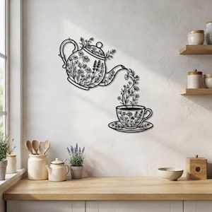 May include: A black metal wall art piece depicting a teapot pouring floral stems into a teacup on a saucer. The teapot and teacup are both decorated with intricate line-art floral patterns, creating a continuous botanical design on the wall.