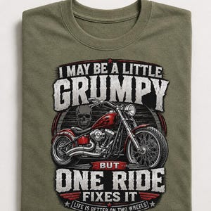 An olive green t-shirt with a graphic of a red motorcycle and a skull, with text that reads, "I may be a little grumpy but one ride fixes it. Life is better on two wheels."