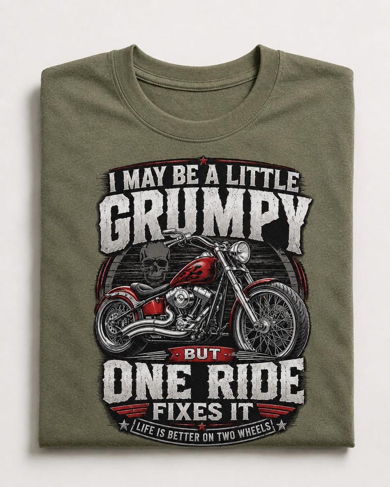 An olive green t-shirt with a graphic of a red motorcycle and a skull, with text that reads, "I may be a little grumpy but one ride fixes it. Life is better on two wheels."