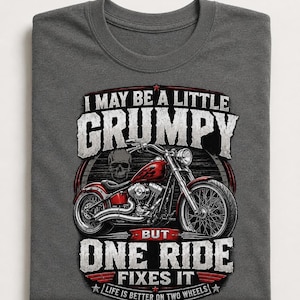 A dark gray t-shirt with a graphic of a red motorcycle and a skull, with text that reads, "I may be a little grumpy but one ride fixes it. Life is better on two wheels."
