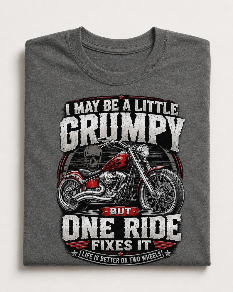 A dark gray t-shirt with a graphic of a red motorcycle and a skull, with text that reads, "I may be a little grumpy but one ride fixes it. Life is better on two wheels."