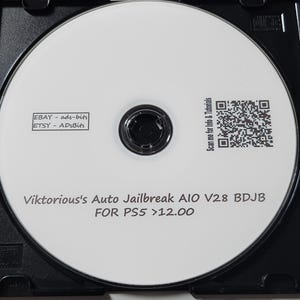 May include: A white optical disc housed in a black plastic case. The disc features printed text reading "Viktorious's Auto Jailbreak A10 V28 BDJB FOR PS5 >12.00", "EBAY - ads-bits", "ETSY - ADsBits", and a QR code labelled "Scan me for Info & Tutorials".