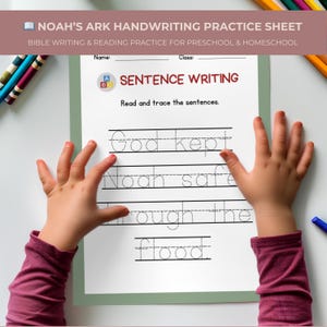 May include: A handwriting practice sheet with the text "NOAH'S ARK HANDWRITING PRACTICE SHEET" and "SENTENCE WRITING". The sheet has lines for tracing sentences about Noah's Ark. A child's hands are on either side of the sheet.