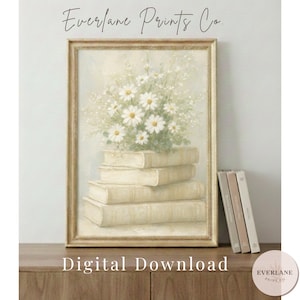 Può includere: Una stampa incorniciata con una pila di libri con un bouquet di margherite bianche. L'opera d'arte ha un'estetica vintage, con colori tenui e una cornice dorata. Il testo "Everlane Prints Co." e "Digital Download" sono visibili.