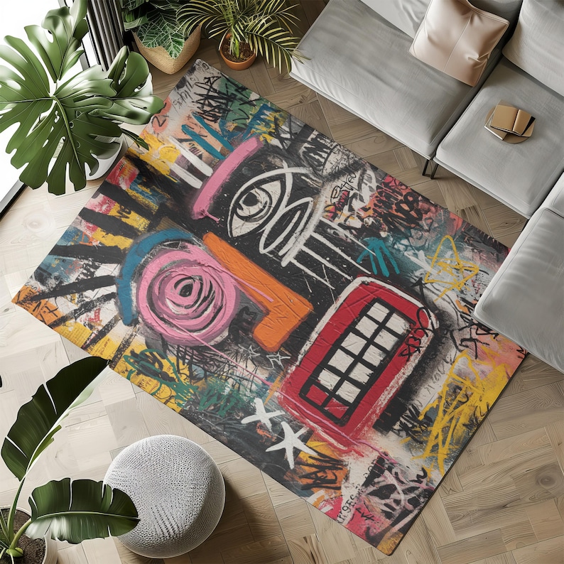 May include: A rectangular area rug with a graffiti-style design. The rug features a black background with colorful abstract shapes, including a pink spiral, orange shapes, and a red telephone booth. White and yellow paint strokes add to the artistic look.