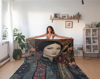 May include: A large, rectangular blanket featuring a portrait of a woman with dark hair and a serene expression. The blanket has a detailed design with floral and patterned elements in shades of blue, red, and gold. The blanket is displayed in a well-lit room.