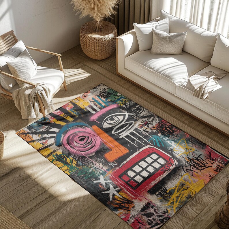 May include: A rectangular area rug with a colorful abstract face design. The rug features a black background with a large pink rose, orange nose, and red mouth. The design includes graffiti-style elements.
