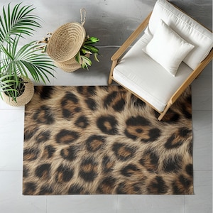 May include: A rectangular rug with a leopard print design. The rug features a pattern of brown and black spots on a tan background, mimicking the appearance of animal fur. The rug is placed on a tiled floor, with a chair and a plant visible.