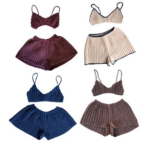 May include: Four sets of knitted two-piece outfits. Each set includes a matching top with spaghetti straps and high-waisted shorts. The sets are in shades of burgundy, beige with navy trim, navy blue, and brown.