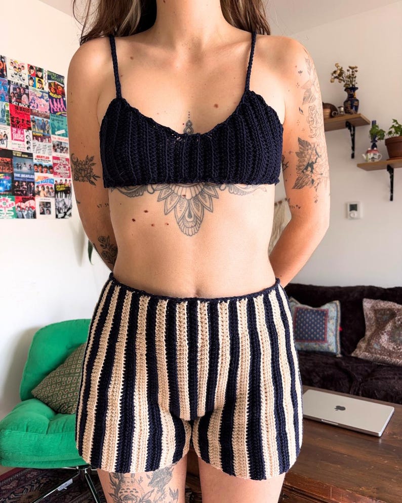 May include: A navy blue crochet top with spaghetti straps and matching striped shorts. The shorts feature alternating beige and navy blue vertical stripes. The handmade set is a comfortable and stylish summer outfit.