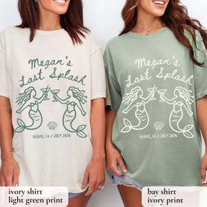 May include: Two t-shirts, one ivory and one bay green, feature the text "Megan's Last Splash" with mermaid illustrations. The shirts also include "MIAMI, FL / JULY 2026". The ivory shirt has a light green print, and the bay shirt has an ivory print.