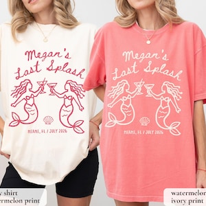 May include: Ivory and watermelon-colored t-shirts with the text "Megan's Last Splash" and mermaid graphics. The shirts also include the location "MIAMI, FL / JULY 2026". The design features two mermaids holding cocktails, a seashell, and the text.