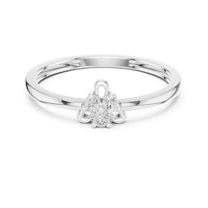 May include: A silver ring featuring a cluster of small, clear, round gemstones. The ring has a thin, smooth band with a split design near the gemstone cluster. The gemstones are arranged in a floral or starburst pattern.