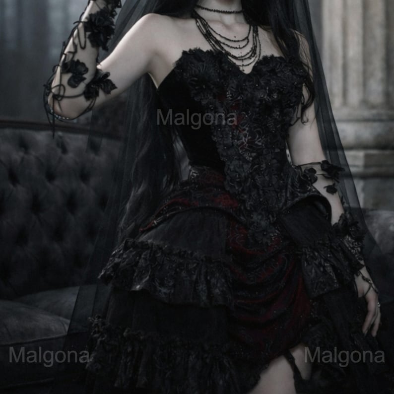 May include: A black strapless corset dress featuring intricate floral lace overlays, a layered ruffled skirt with deep red fabric accents, and matching lace arm sleeves. A sheer black veil and a multi-layered beaded necklace complete the ensemble.