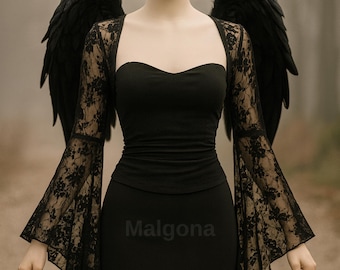 May include: A black strapless top with long, flared lace sleeves featuring a floral pattern, paired with a matching black skirt. Large, dark, feathered wings are attached to the back. The word Malgona is printed in small, dark letters on the skirt.