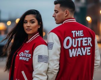 May include: Two people wearing matching red and cream varsity jackets. The jackets have the text "THE OUTER WAVE" in white block letters on the back and front. An American flag patch is on the sleeve.
