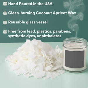 A candle in a clear or amber glass jar with a white label that reads “Smells Like We Can Walk Around Naked Again... Congratulations, empty nesters!!” placed on a simple, neutral background.