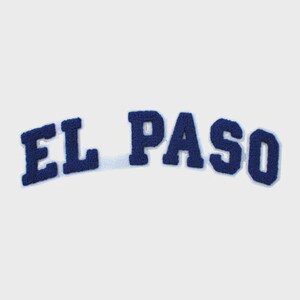 May include: A navy blue felt patch with the text "EL PASO" in a curved arrangement. The letters are in a bold, block style with a white border, set against a plain white background.