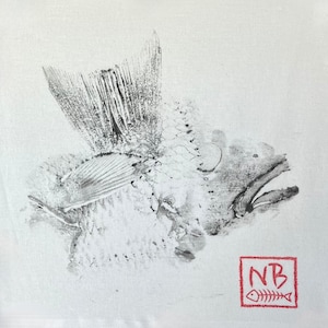 May include: A black and white fish print on a white background. The fish is depicted in a detailed, artistic style, with visible scales and fins. A red square with the initials "NB" and a fish skeleton is in the lower right corner.
