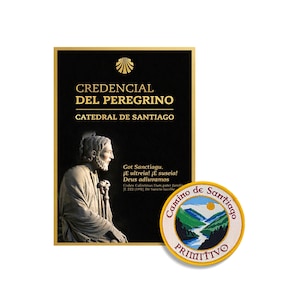 May include: A black rectangular pilgrim credential document featuring a gold scallop shell icon, the text CREDENCIAL DEL PEREGRINO CATEDRAL DE SANTIAGO, and a statue of a bearded figure, alongside a round embroidered patch with a mountain landscape.