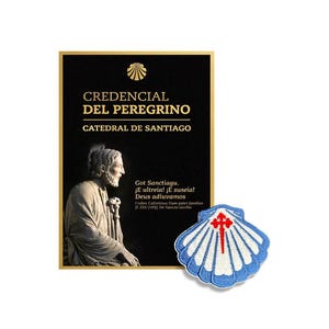 May include: A black Credencial del Peregrino document from the Catedral de Santiago featuring a gold scallop shell icon, text, and a statue of a figure, accompanied by a blue and white scallop shell patch with a red cross of Saint James.