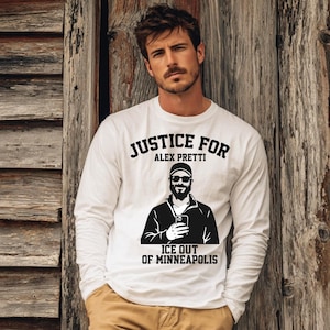 May include: White long-sleeve shirt with the text "JUSTICE FOR ALEX PRETTI" above a black and white illustration of a man holding a phone. The text "ICE OUT OF MINNEAPOLIS" is below the illustration.