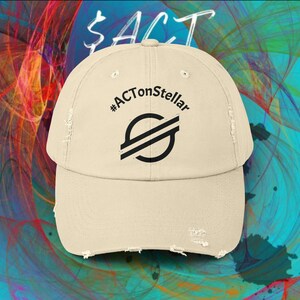 May include: A beige baseball cap with a distressed, worn-in brim and front panel. The cap features the black text #ACTonStellar printed above a black circular logo containing two diagonal lines, centred on the front of the crown.