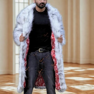 May include: A long, faux fur coat in shades of white and gray, with a red patterned lining. The coat has a wide collar and a full length design. The coat is open, revealing a black shirt and dark wash jeans.