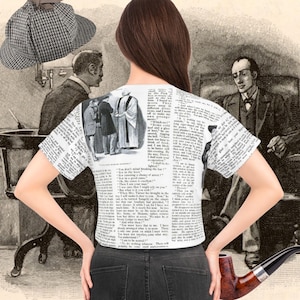 May include: A white crop top with a newspaper print design featuring illustrations of Sherlock Holmes. The shirt is paired with black jeans. A Sherlock Holmes-style hat and a pipe are also visible in the image, evoking a detective theme.