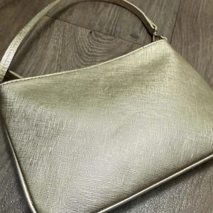 Bolso de mano/clutch dorado metalizado de Kate Spade