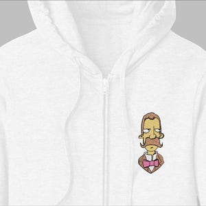 May include: White zip-up hoodie with a cartoon illustration of a man with a brown mustache, hair, and suit, and a pink bow tie. The hoodie has a hood and a zipper down the front. The illustration is embroidered on the left chest.