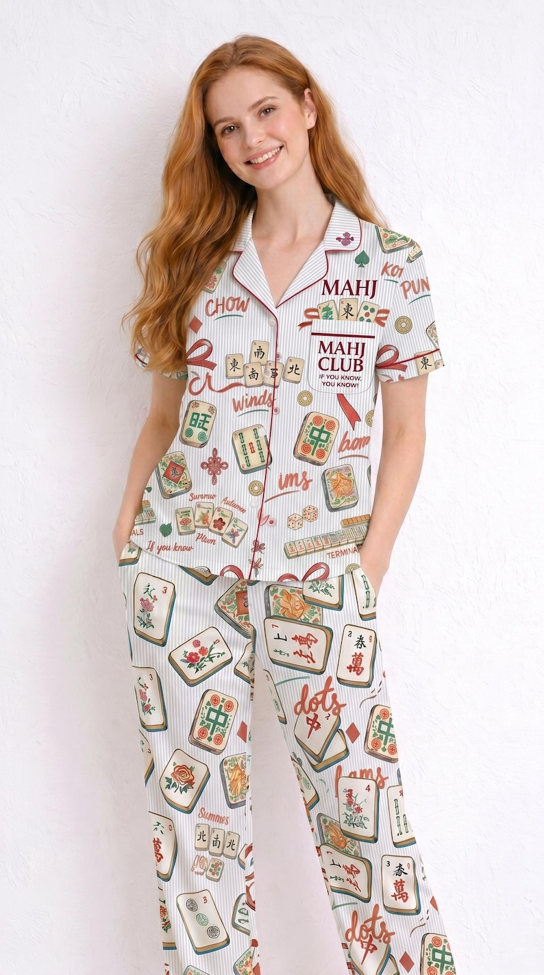 May include: White pajama set with a vertical striped pattern and a Mahjong tile print. The short-sleeved top and pants feature red trim and text including "MAHJ CLUB" and "If you know, you know."