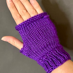 May include: Purple fingerless knitted gloves with a ribbed cuff.