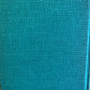 May include: A teal green book cover with a textured fabric finish.