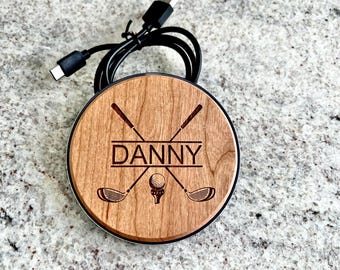 May include: A wooden wireless charging pad with a black charging cable. The pad is engraved with a golf club design and the name "DANNY".
