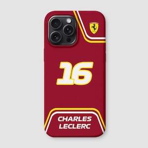May include: A red phone case with the number 16 in yellow with a white outline. The case has a yellow and white stripe design and the name "CHARLES LECLERC" printed in white. A yellow Ferrari logo is visible.