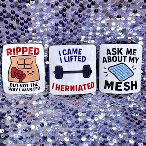 May include: Three white square stickers with humorous text and illustrations. One says "RIPPED" with an illustration of a torso and the text "BUT NOT THE WAY I WANTED." Another says "I CAME I LIFTED I HERNIATED" with a barbell. The last says "ASK ME ABOUT MY MESH."
