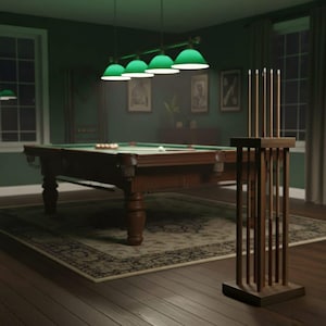 May include: A dimly lit billiards room with a green felt pool table, balls, and cues. Overhead, four green lamps illuminate the scene. A wooden cue rack stands in the foreground, and a patterned rug covers the floor.